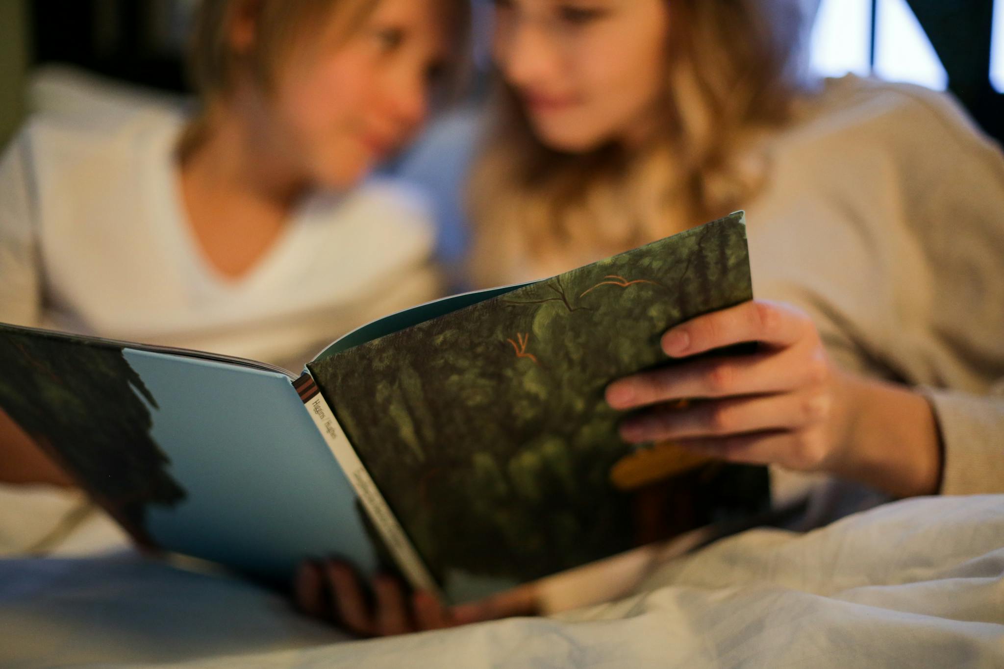 Two children enjoying a bedtime story together, fostering imagination and bonding.